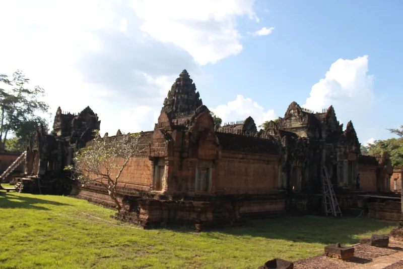 Sandstone towers and galleries of an ancient Khmer temple rise above green lawns near Siem Reap.