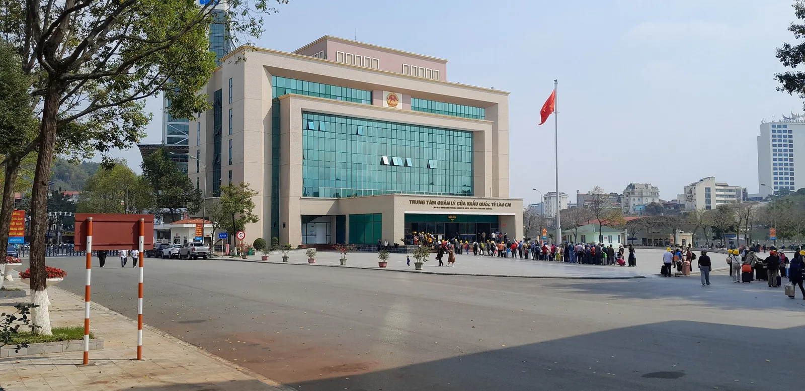 The Lao Cai international border gate building with a queue of travelers waiting outside near Sapa.