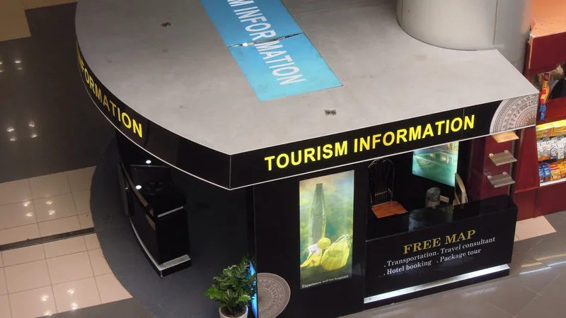 A tourism information kiosk offering free maps and hotel booking services at Noi Bai International Airport in Hanoi.