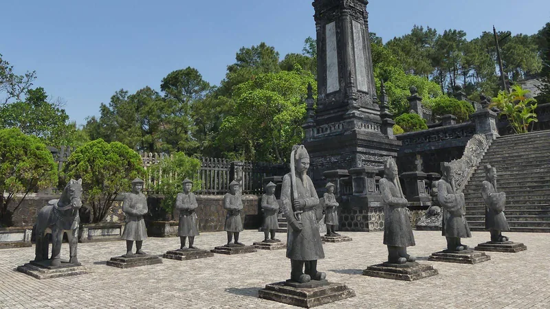 Stone statues of mandarins and a horse guard a stele pavilion at Khai Dinh Tomb near Hue.