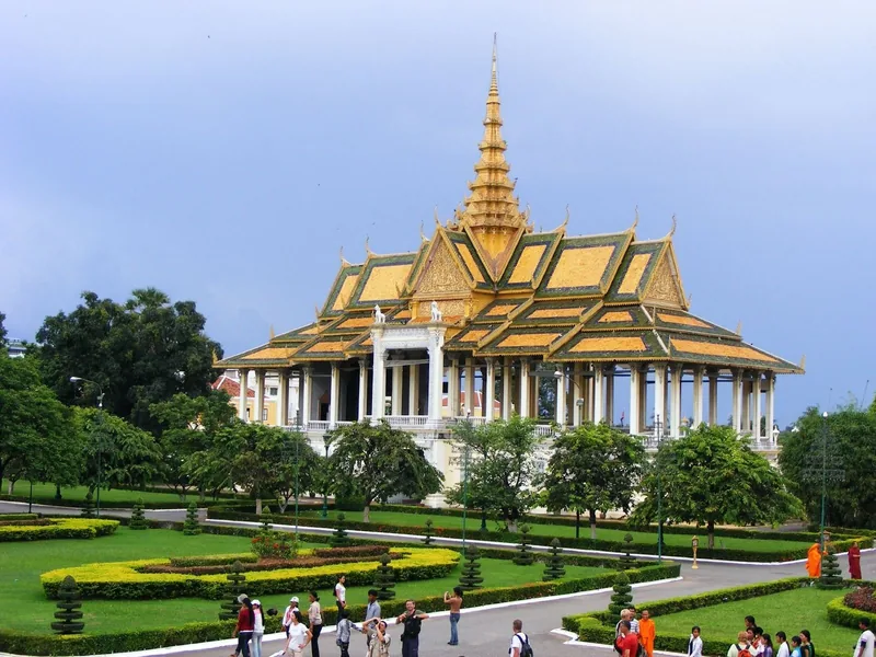 The golden-spired throne hall of the Royal Palace complex rises above manicured gardens in Phnom Penh.