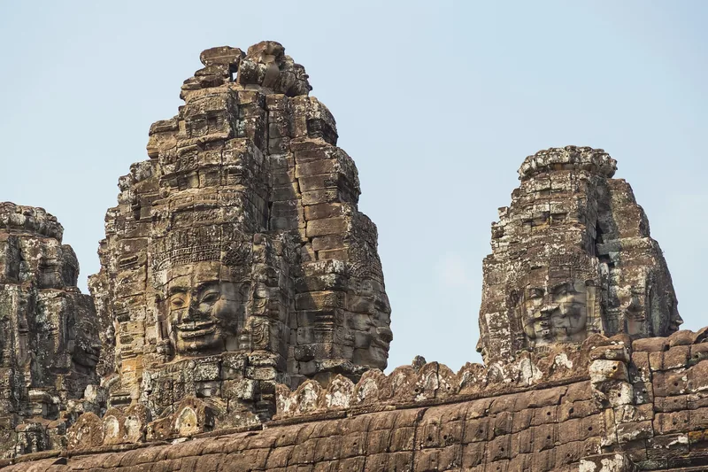 Stone towers carved with serene smiling faces rise at Bayon Temple in Angkor Thom, Siem Reap.