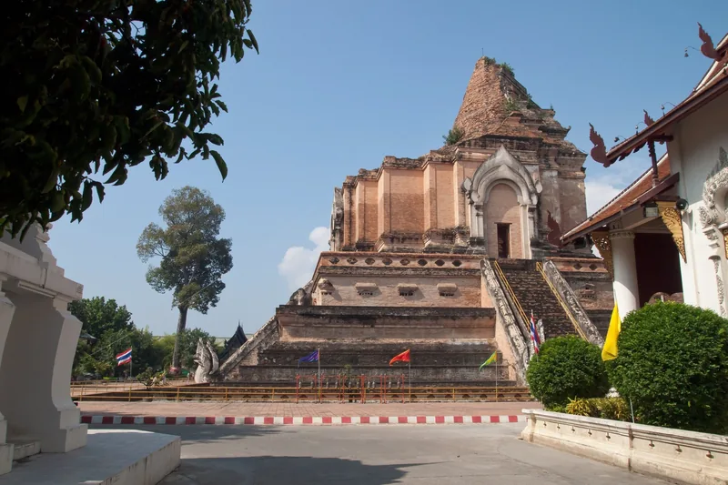 The weathered brick chedi of Wat Chedi Luang rises above stone stairways in Chiang Mai.